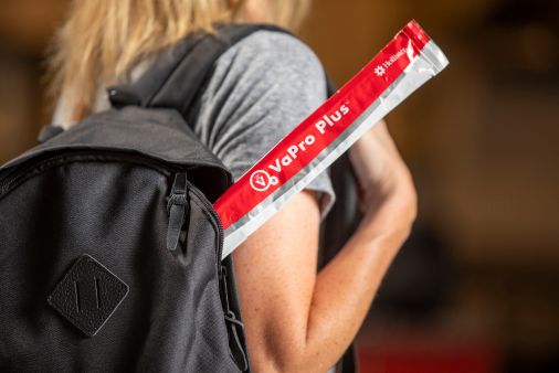 a person holding a red and white card