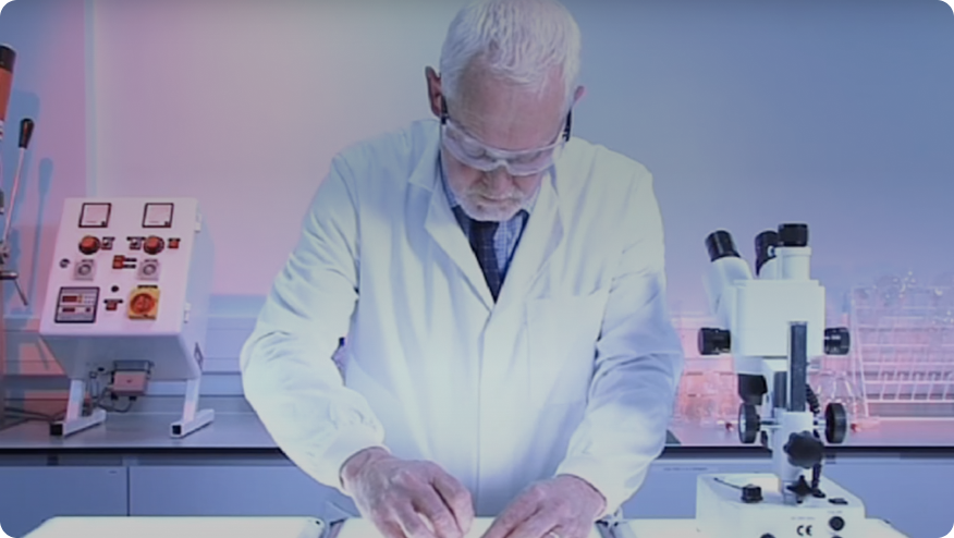 a man in a lab coat looking at a tablet