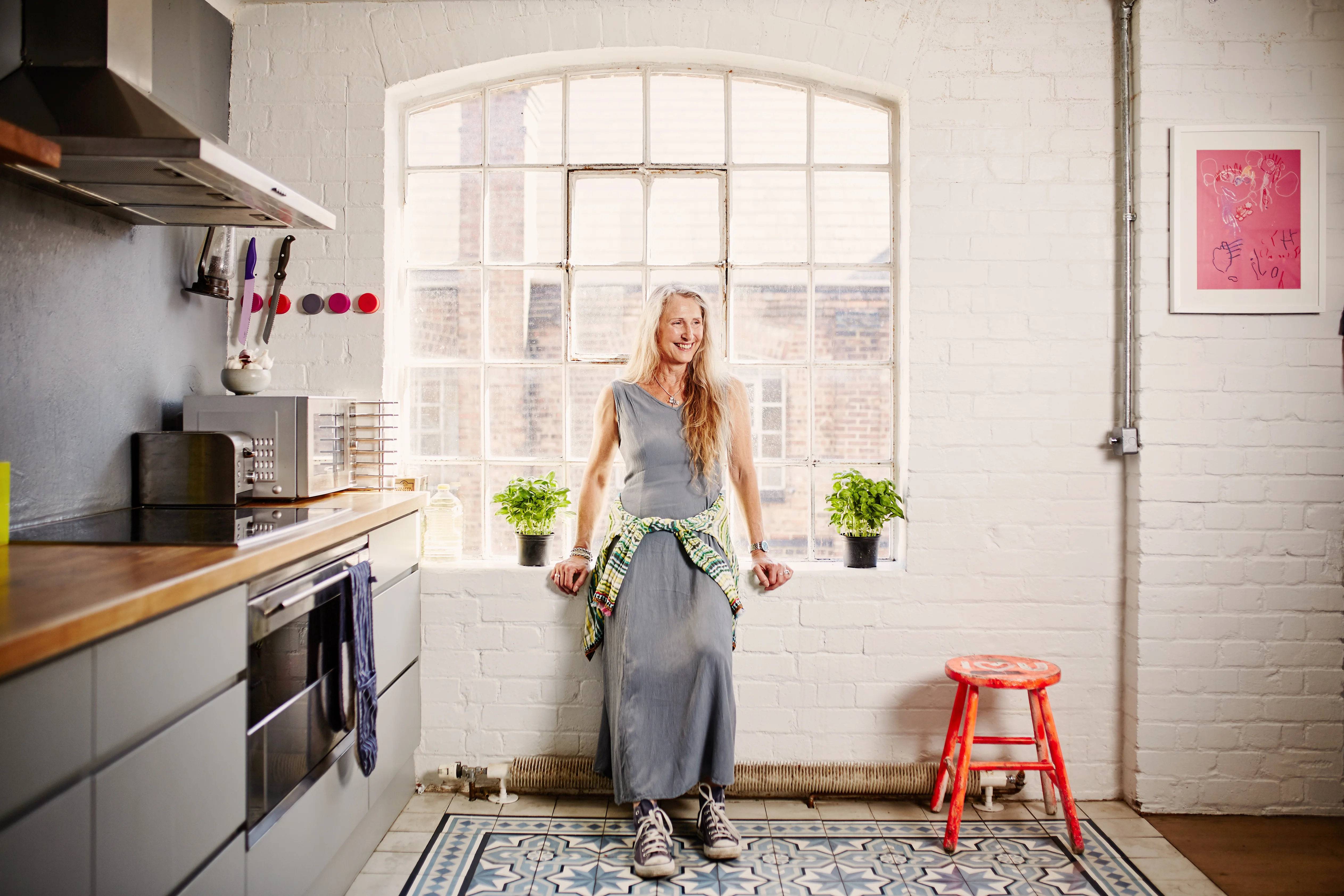 Woman standing in her kitchen 