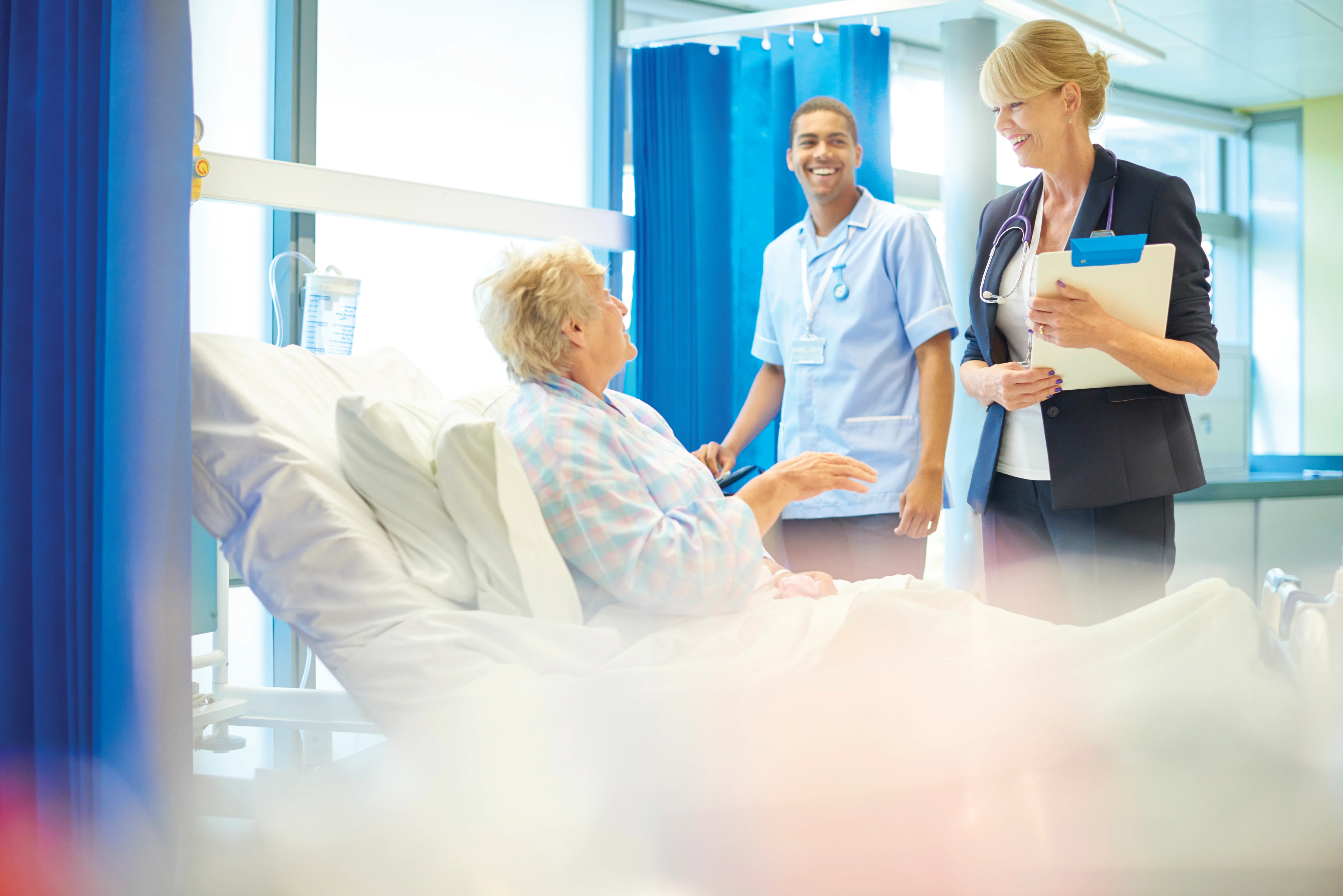 a few medical professionals looking at a patient